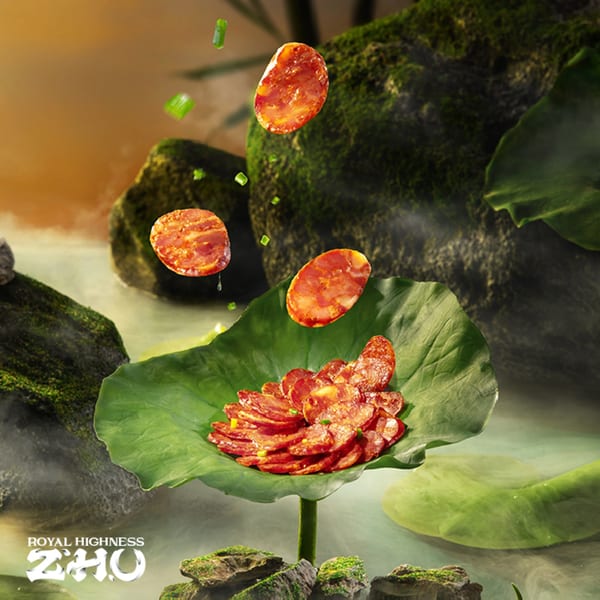 Sliced Chinese sausage on a lotus leaf, with more slices and green onions floating above.